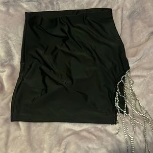 Black stretchy skirt with rhinestone detail.